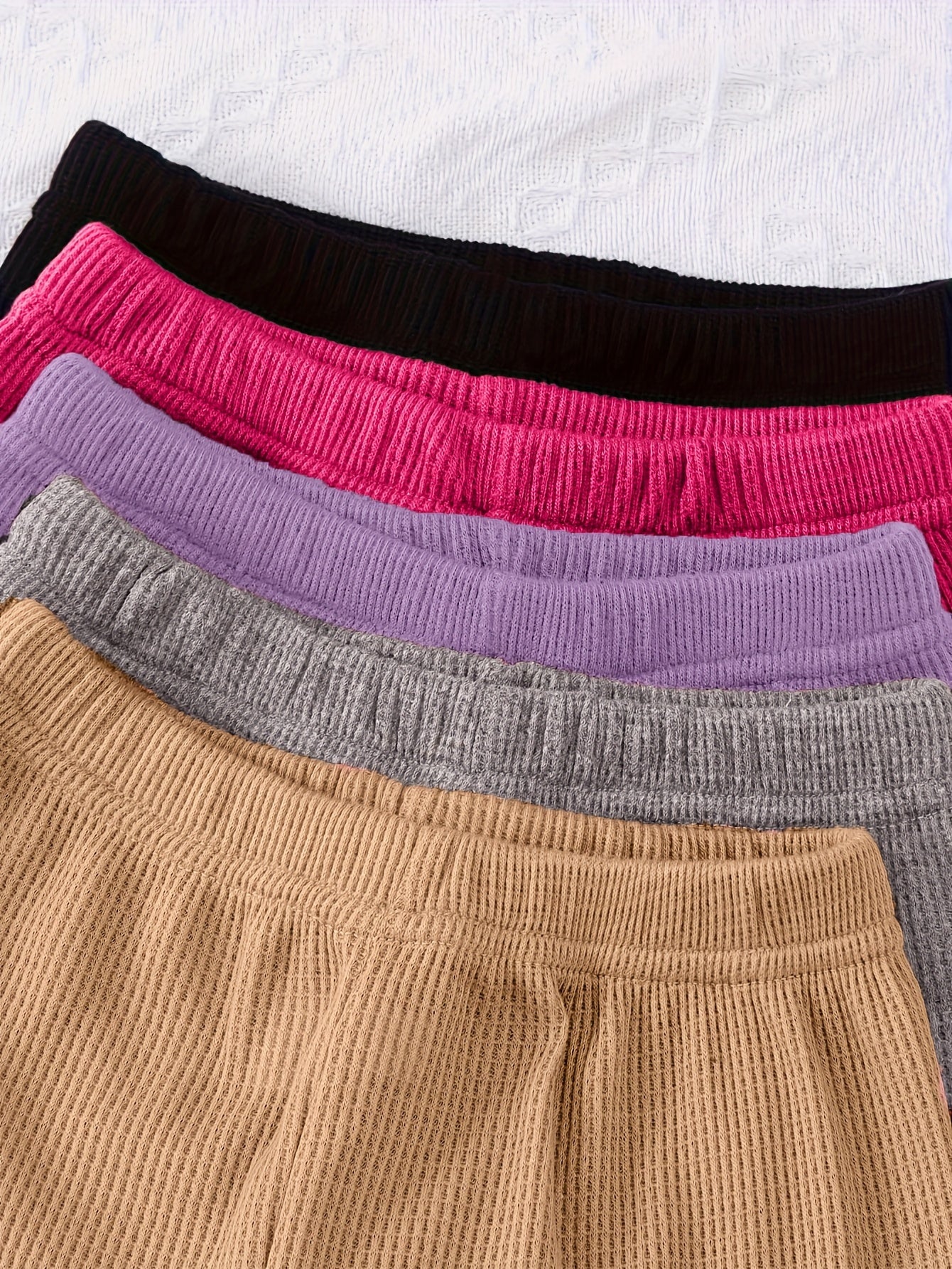 10-piece girls' solid color waffle-knit loungewear sets, featuring long-sleeve tops and matching pants made from soft and comfortable fabric.