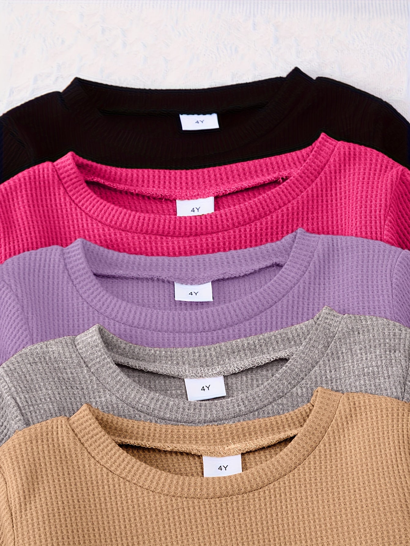 10-piece girls' solid color waffle-knit loungewear sets, featuring long-sleeve tops and matching pants made from soft and comfortable fabric.