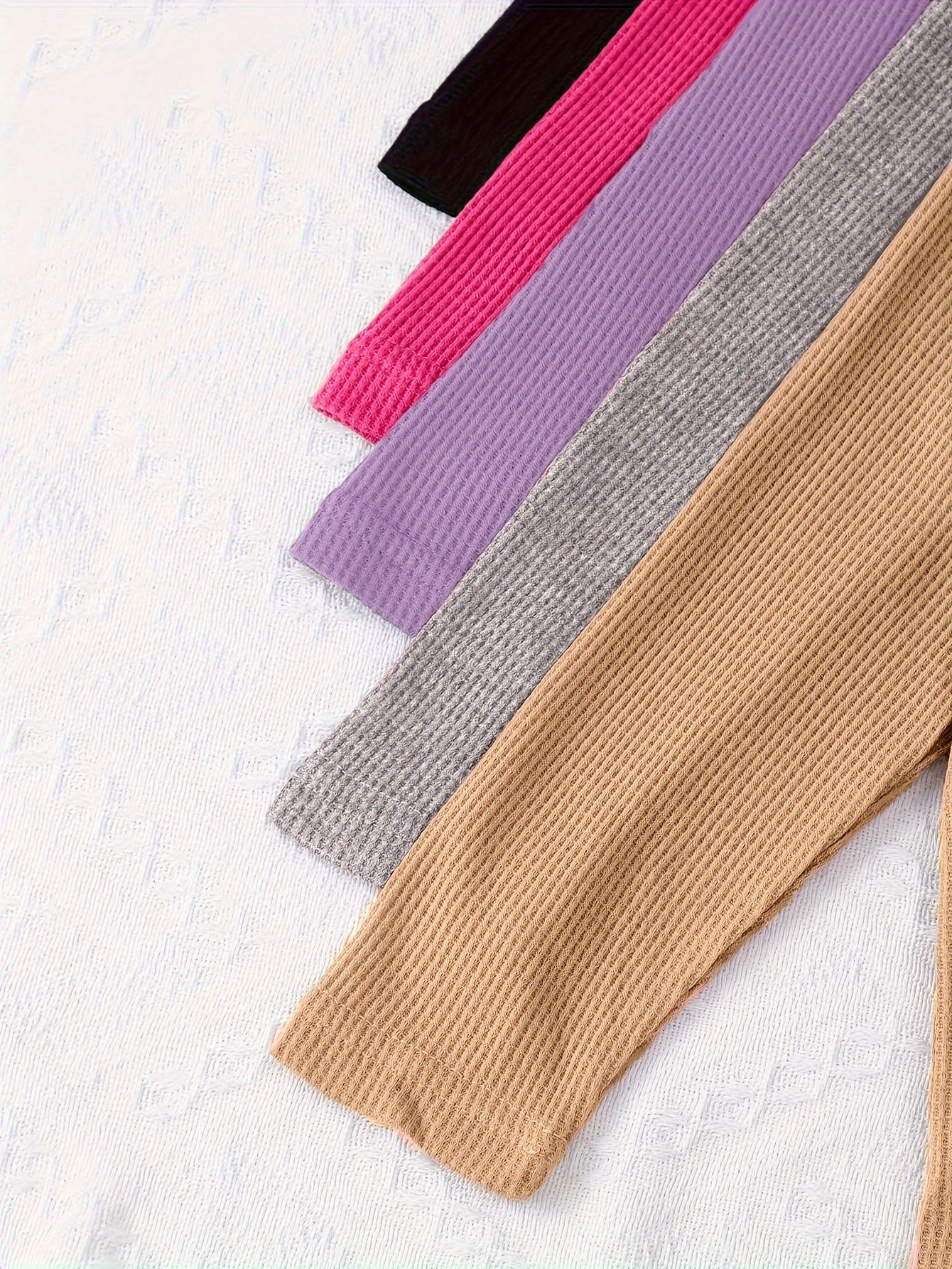 10-piece girls' solid color waffle-knit loungewear sets, featuring long-sleeve tops and matching pants made from soft and comfortable fabric.